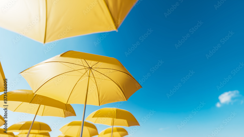 Yellow beach umbrellas against the blue sky