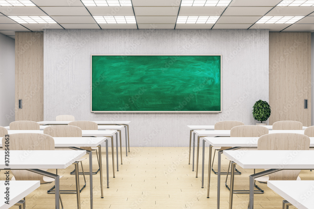 Light classroom interior with empty green chalkboard