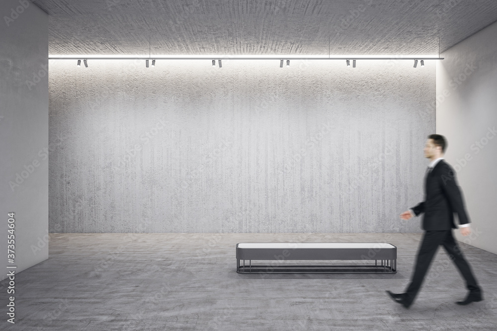 Businessman walking in exhibition hall interior