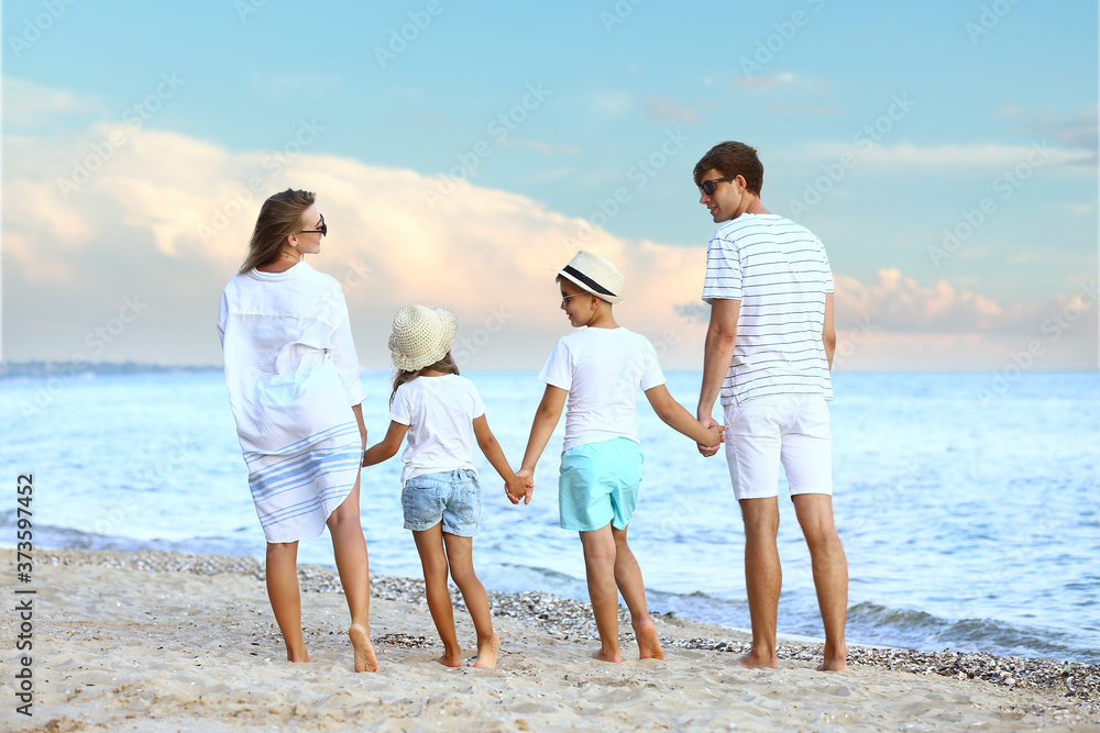 Happy family on sea beach at resort