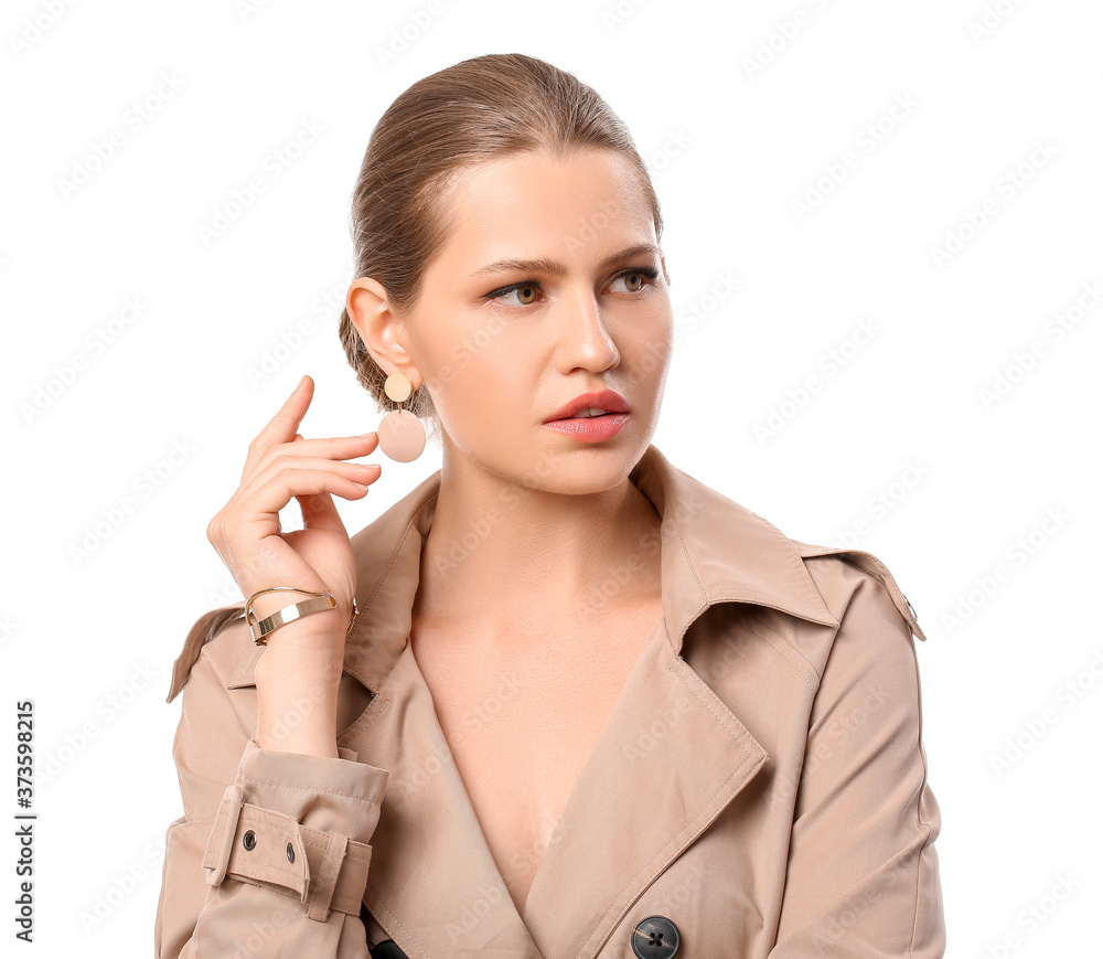 Beautiful young woman wearing stylish jewelry on white background