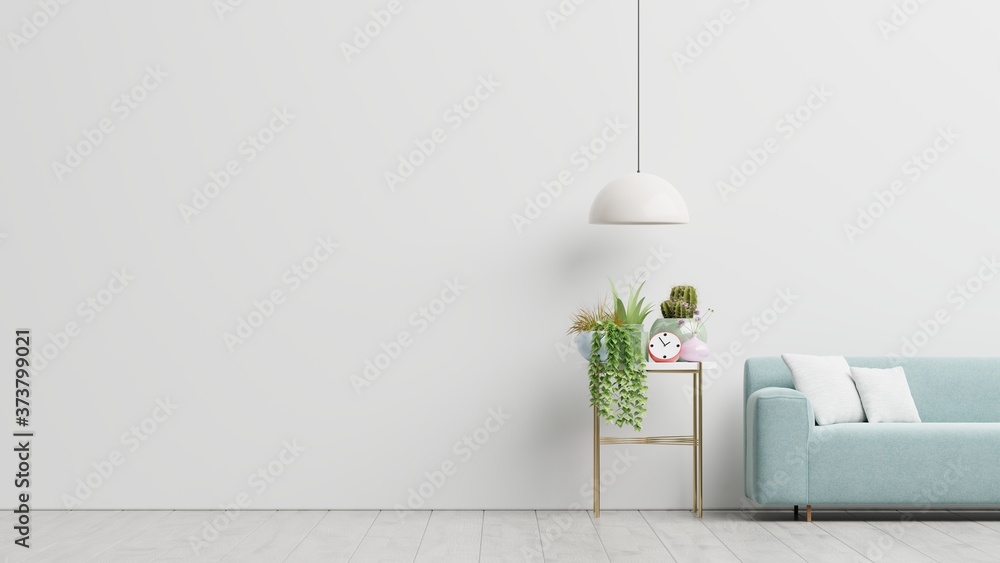 Empty living room with blue sofa, plants and table on empty white wall background.