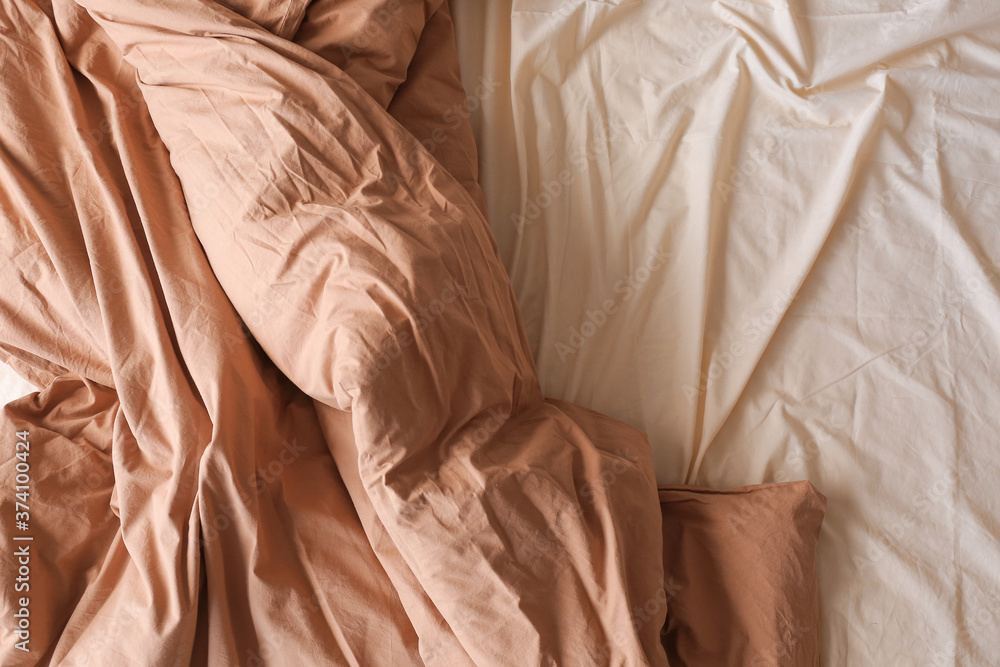 Clean sheet with blanket on bed, top view