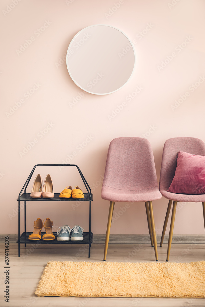 Shoe stand with mirror and chairs in interior of hall