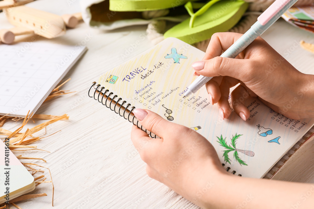 女人在列旅行物品清单