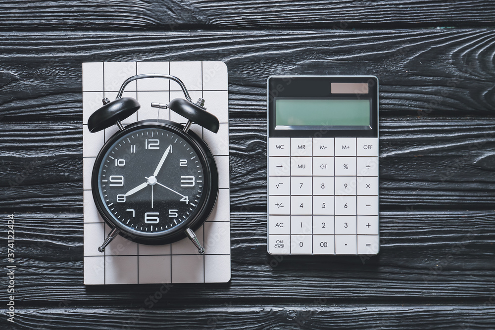 Alarm clock with calculator on table