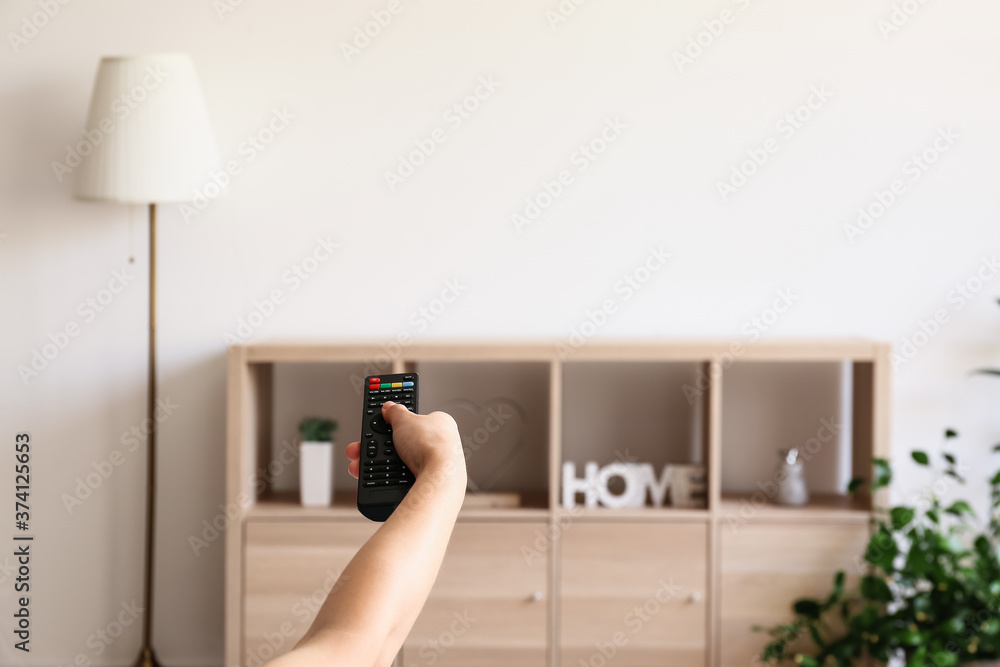 Young woman watching TV at home