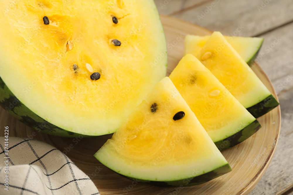 Cut yellow watermelon on table