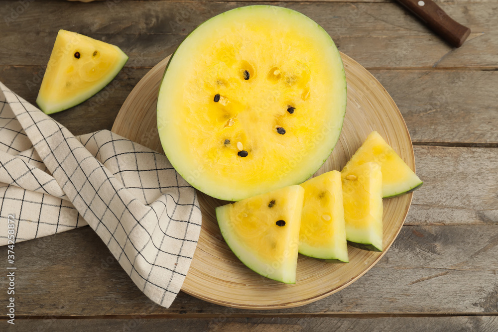 Cut yellow watermelon on table