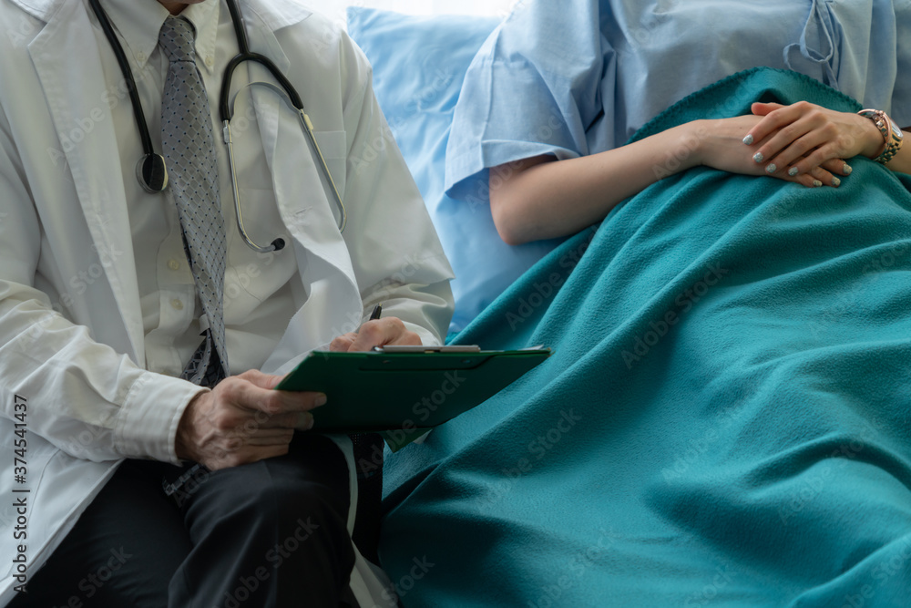 Doctor in professional uniform examining patient at hospital or medical clinic. Health care , medica