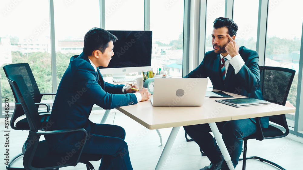 Two business people talk project strategy at office meeting room. Businessman discuss project planni