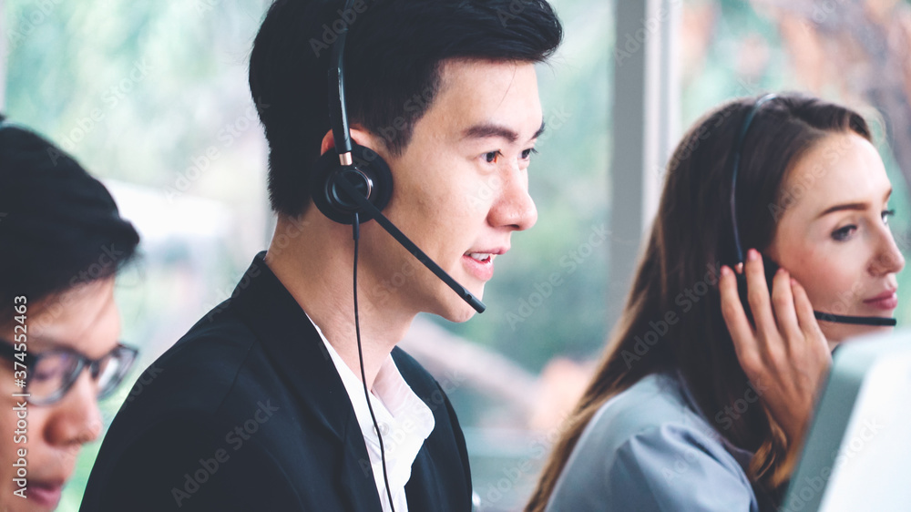 Business people wearing headset working in office to support remote customer or colleague. Call cent