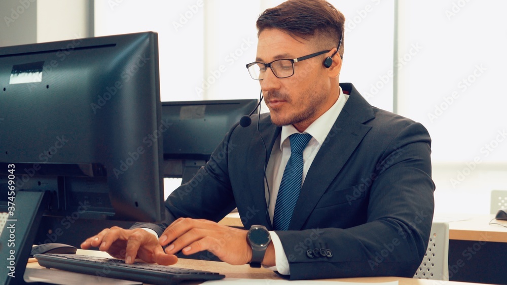 Business people wearing headset working in office to support remote customer or colleague. Call cent