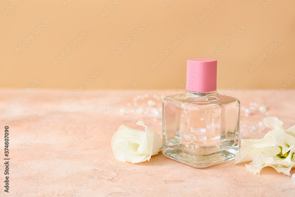 Bottle of perfume on color background