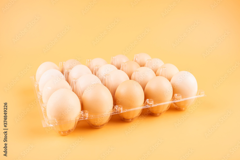 Eggs in a plate on yellow background