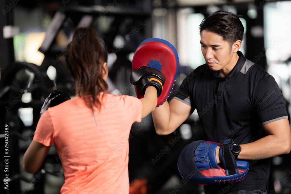 personal trainer is practicing boxing