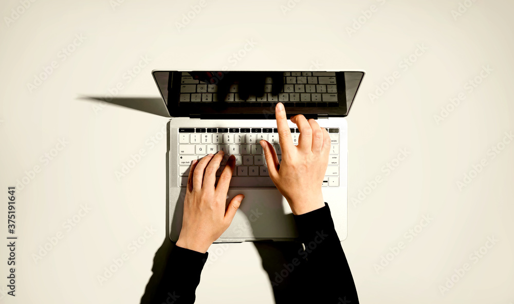 Person using a laptop computer from above