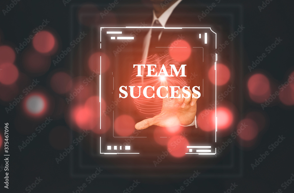 Businessman uses finger touch the word TEAM SUCCESS  on fingerprints in the channel graph on the bla