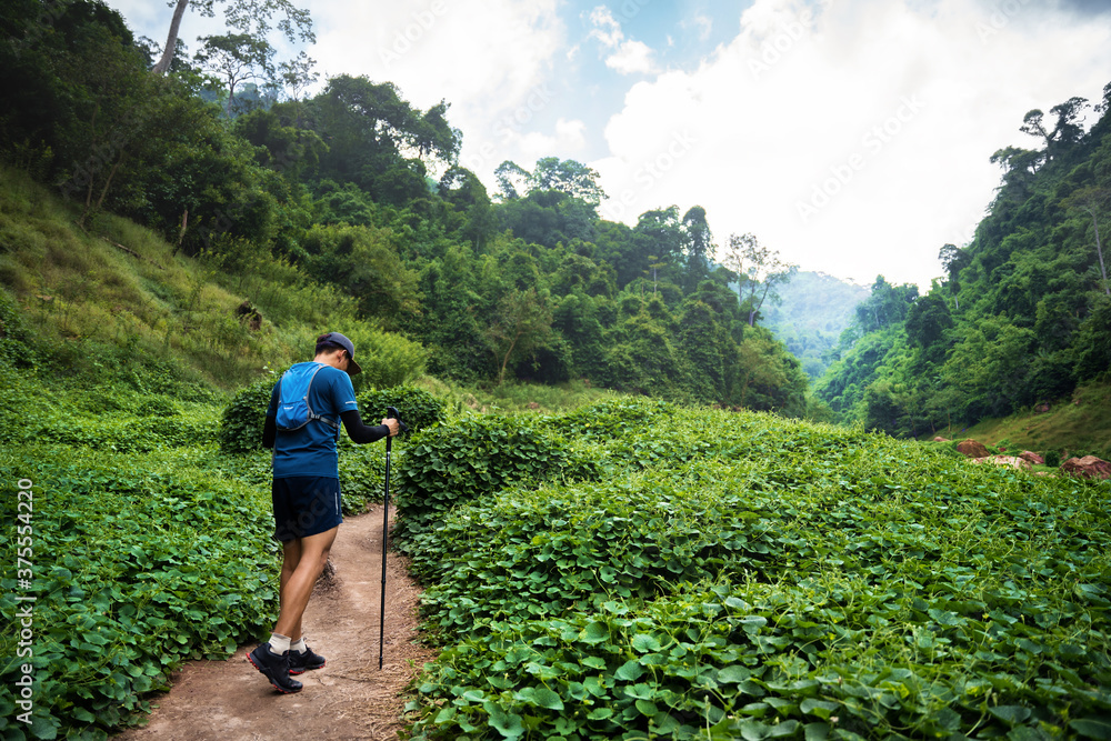 跑步者，他在跑一条小径。在山地自然小径上