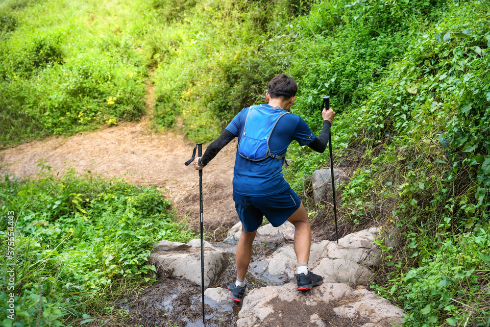 Runner, hes running a trail. In the mountain nature trail