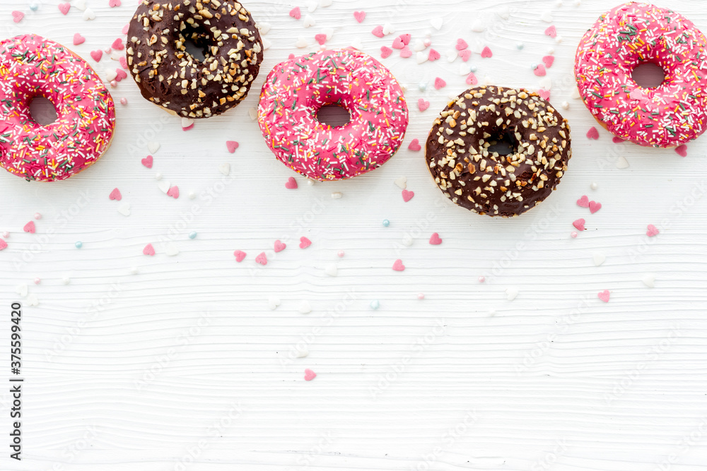 Donuts flat lay pattern on white background, top view