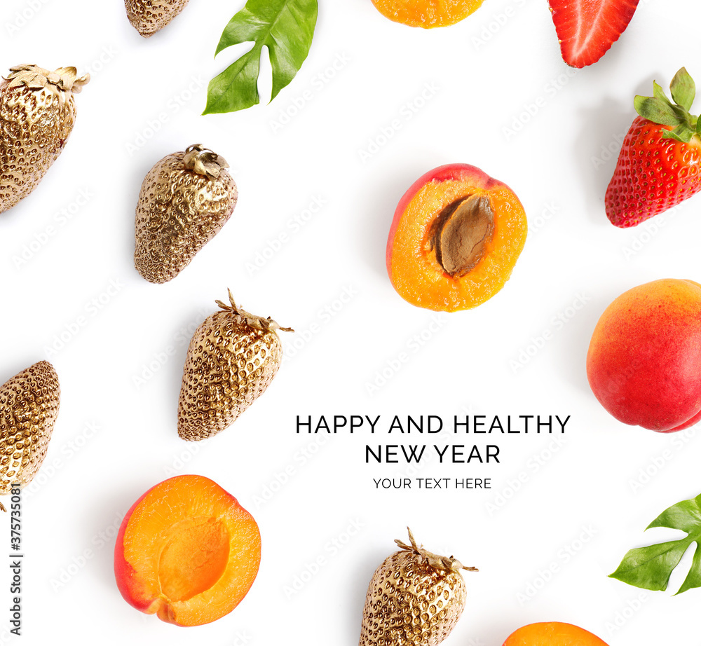 Creative happy and healthy new year card made of strawberry and apricot on the white background.Gold