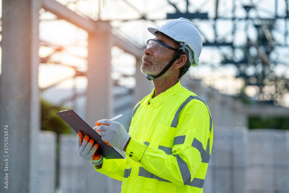 Engineer working about project in building construction site.