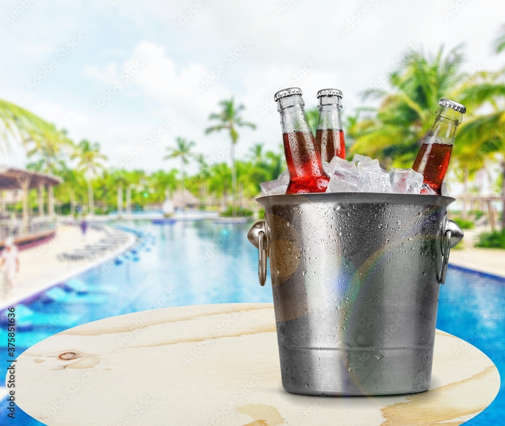 Bottles of cold and fresh beer with ice in the bucket