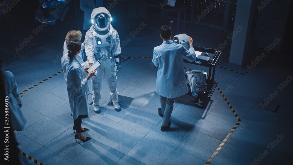 Team of Aerospace Scientists and Engineers Wearing White Coats have Discussion, Use Computers, Const