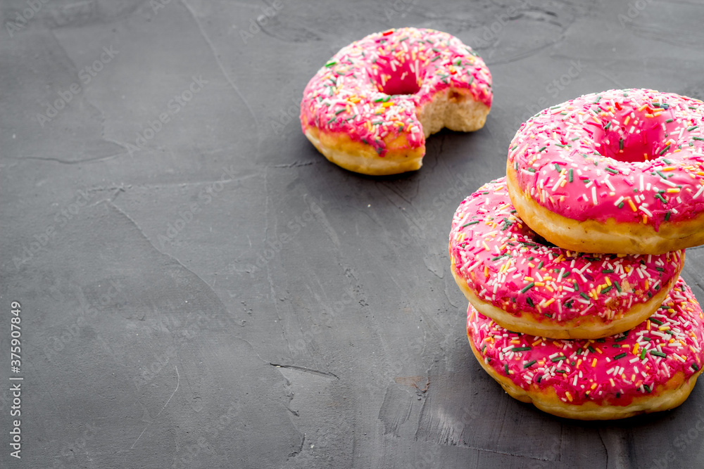 Pink berry donuts close up. Glazed and sprinkles bakery