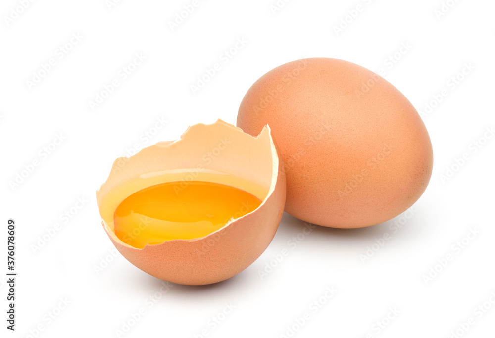 Chicken egg and half with yolk isolated on a white background.