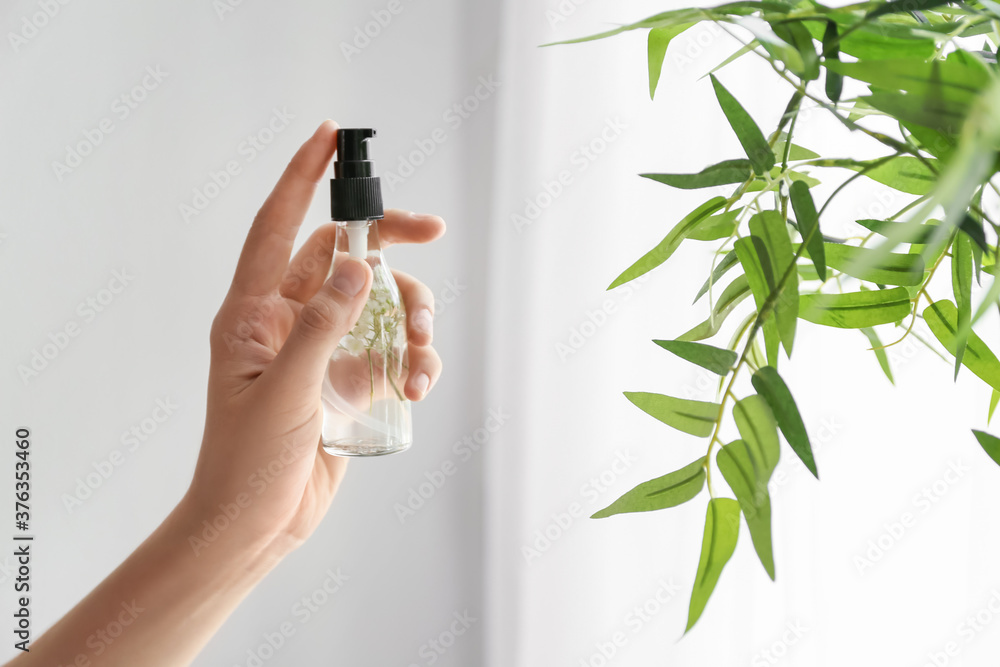 Woman using natural air freshener at home