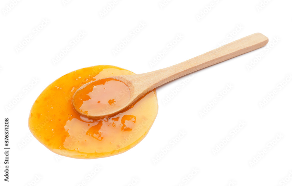 Spoon with tasty apricot jam on white background