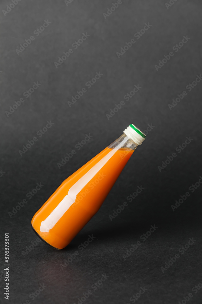 Bottle of juice on dark background