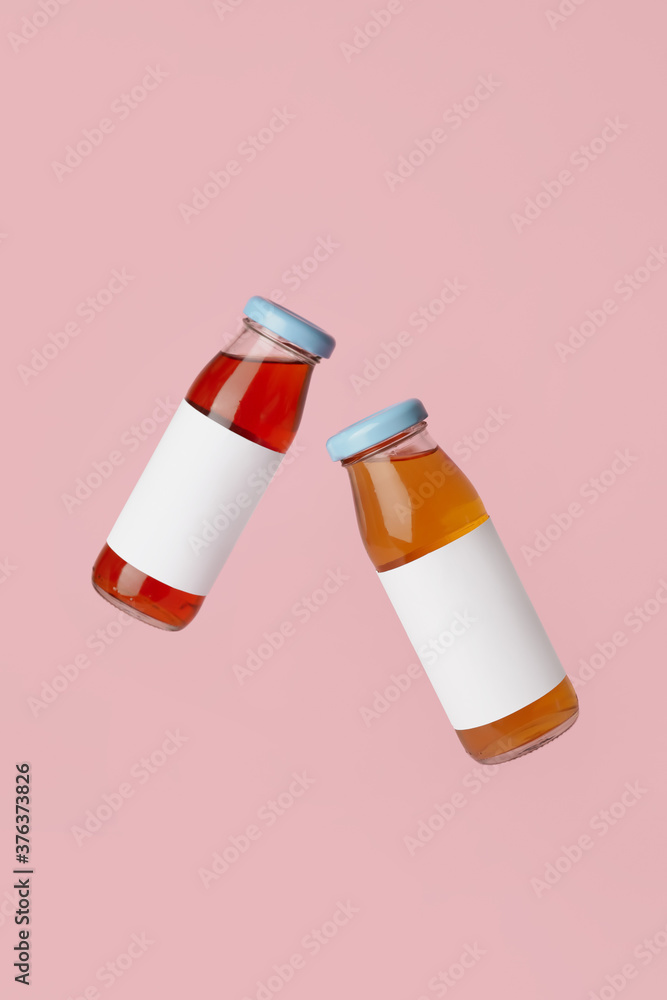 Bottles of juices on color background