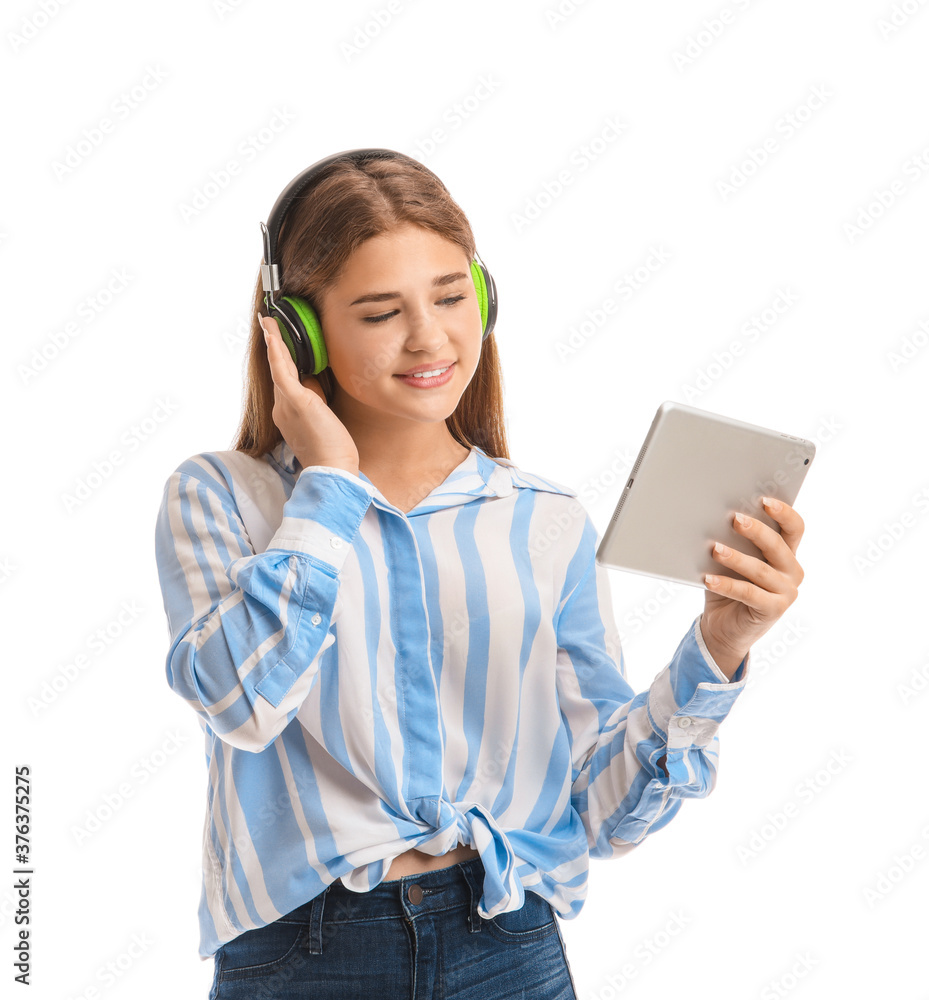 Teenage girl listening to music on white background