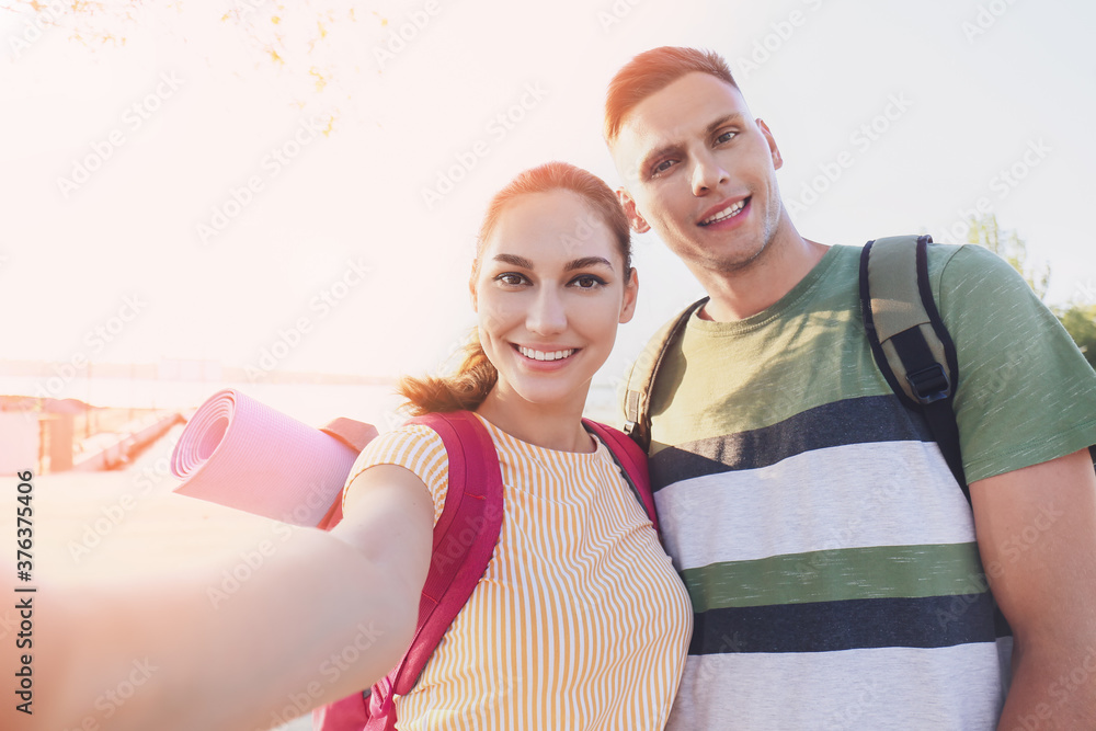 Couple of tourists taking photo on city street