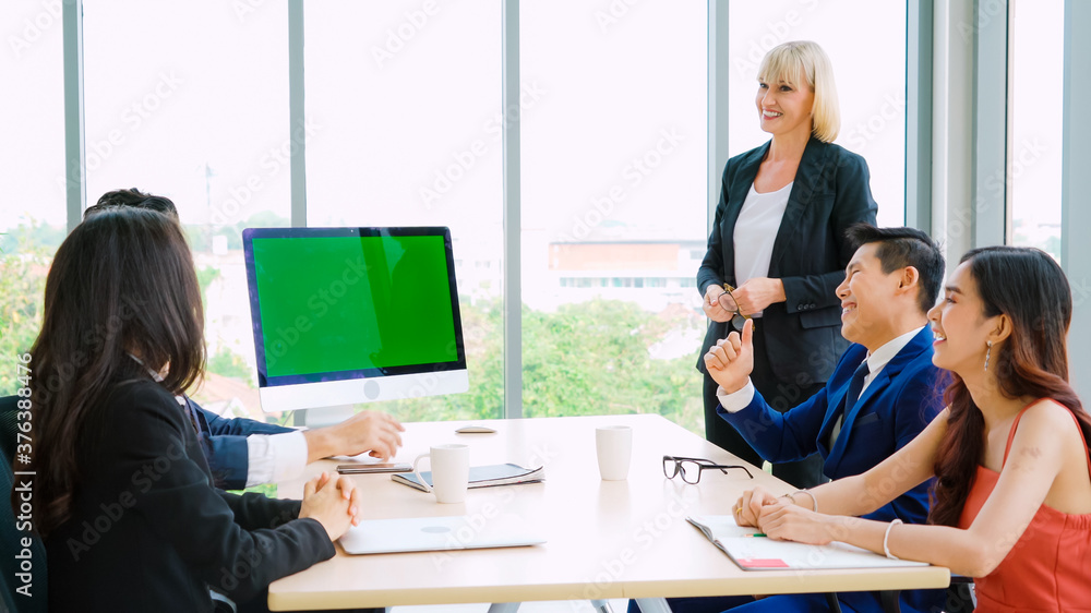 Business people in the conference room with green screen chroma key TV or computer on the office tab