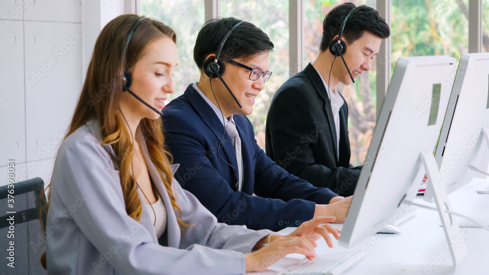 Business people wearing headset working in office to support remote customer or colleague. Call cent