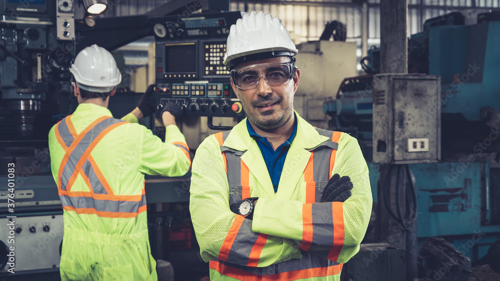 Young factory worker or engineer close up portrait in factory . Industry and engineering concept .