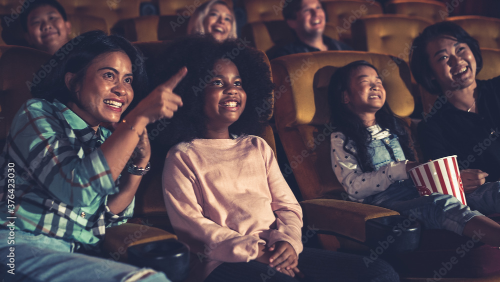 People audience watching movie in the movie theater cinema. Group recreation activity and entertainm