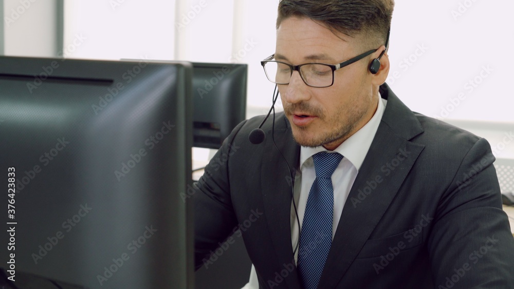 Business people wearing headset working in office to support remote customer or colleague. Call cent