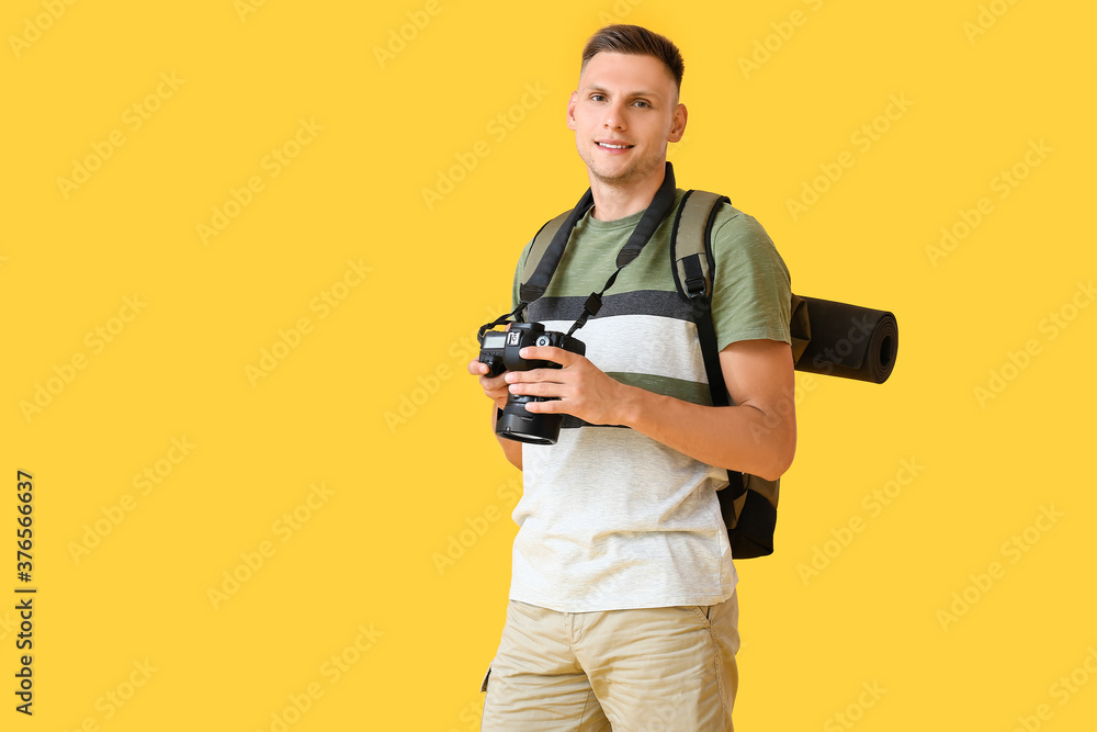 Male tourist on color background