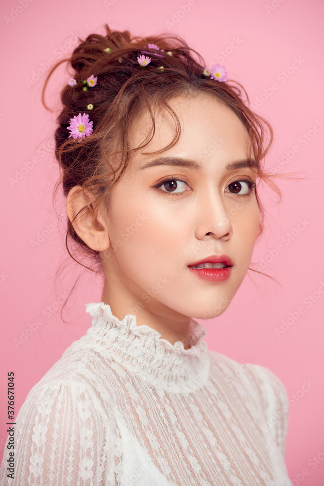 Beautiful Girl with Flowers. Face Closeup. Makeup and Hairstyle