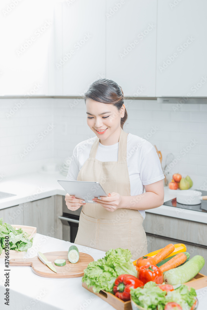 elegant housewife found new recipe for cooking in kitchen