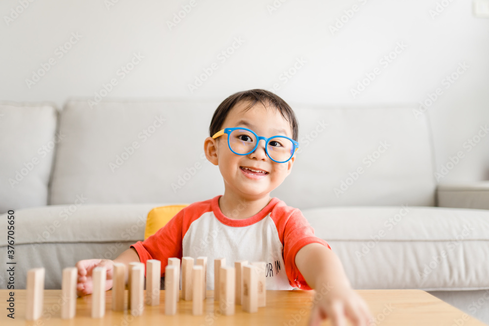 3 years old boy.toddler child playing with lots of wooden toys block with mother.Kids play with educ