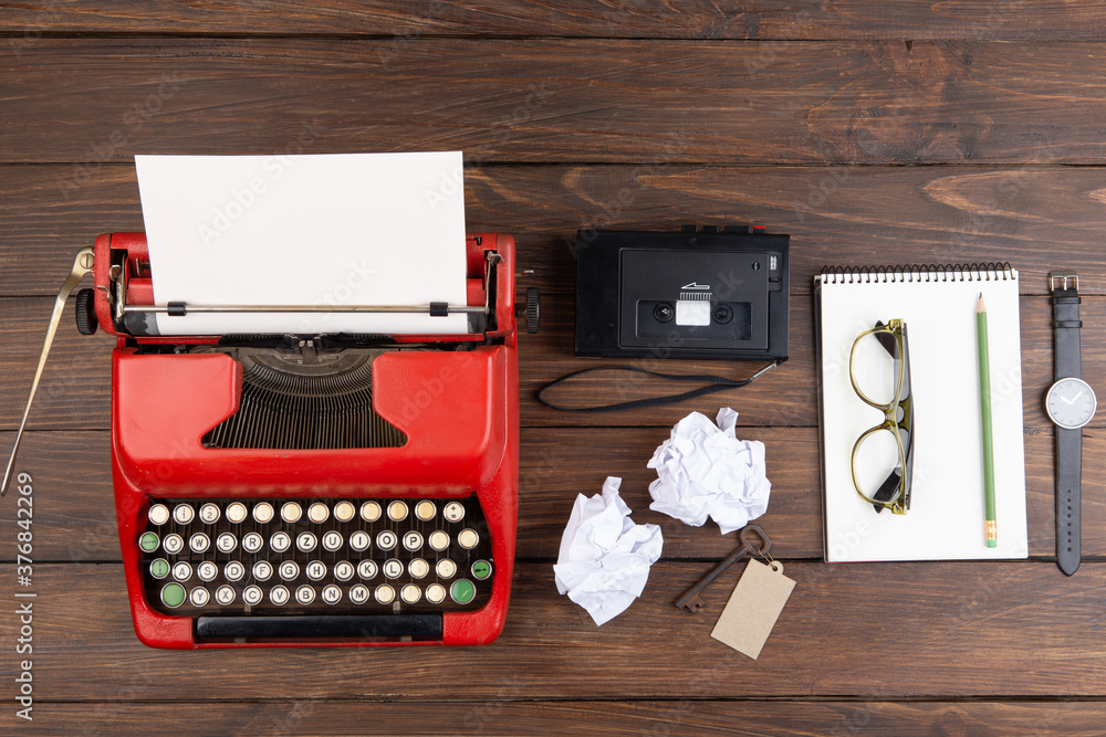 Journalism or blogging concept vintage typewriter on the wooden desk, top view