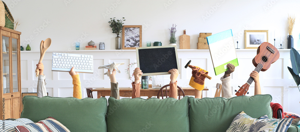 Children are holding books, toys, and a keyboard. Educational concept	
