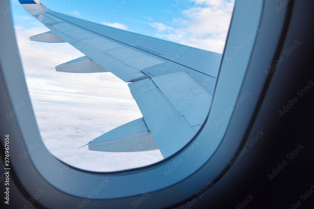 Plane passenger view on a wing with day time skies.