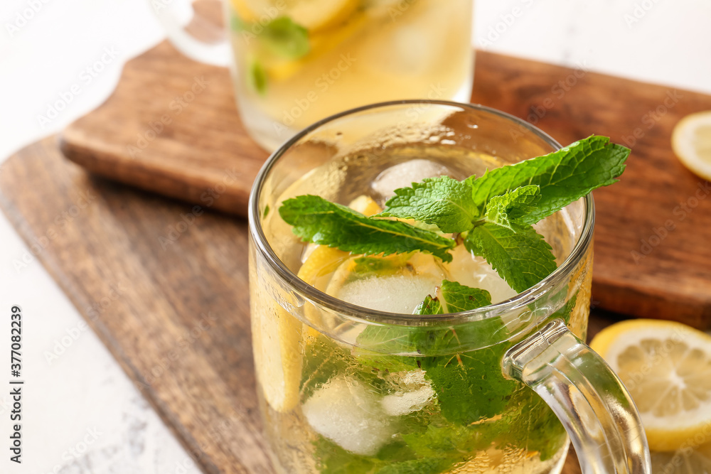 Cup of tasty cold ice tea on table, closeup